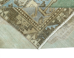 A corner of a vintage handmade Turkish rug showing its wool pile and cotton foundation.