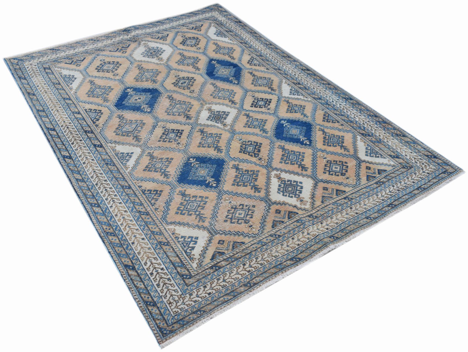 A vintage Persian rug featuring a traditional geometric diamond pattern in blue and beige tones.