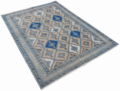 A vintage Persian rug featuring a traditional geometric diamond pattern in blue and beige tones.