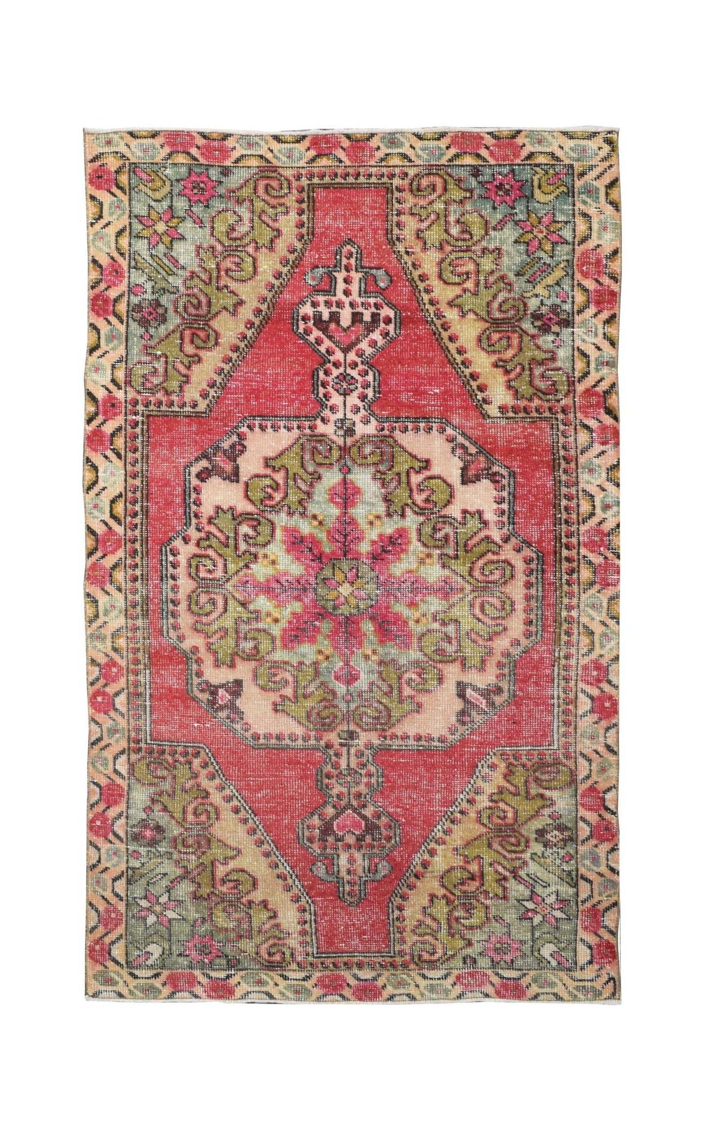 A vintage handmade Turkish wool rug featuring a central medallion in red, green, and beige tones.