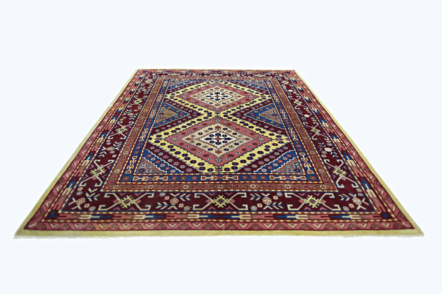 A vintage handmade Turkish rug featuring a geometric diamond pattern in red, blue, and yellow.
