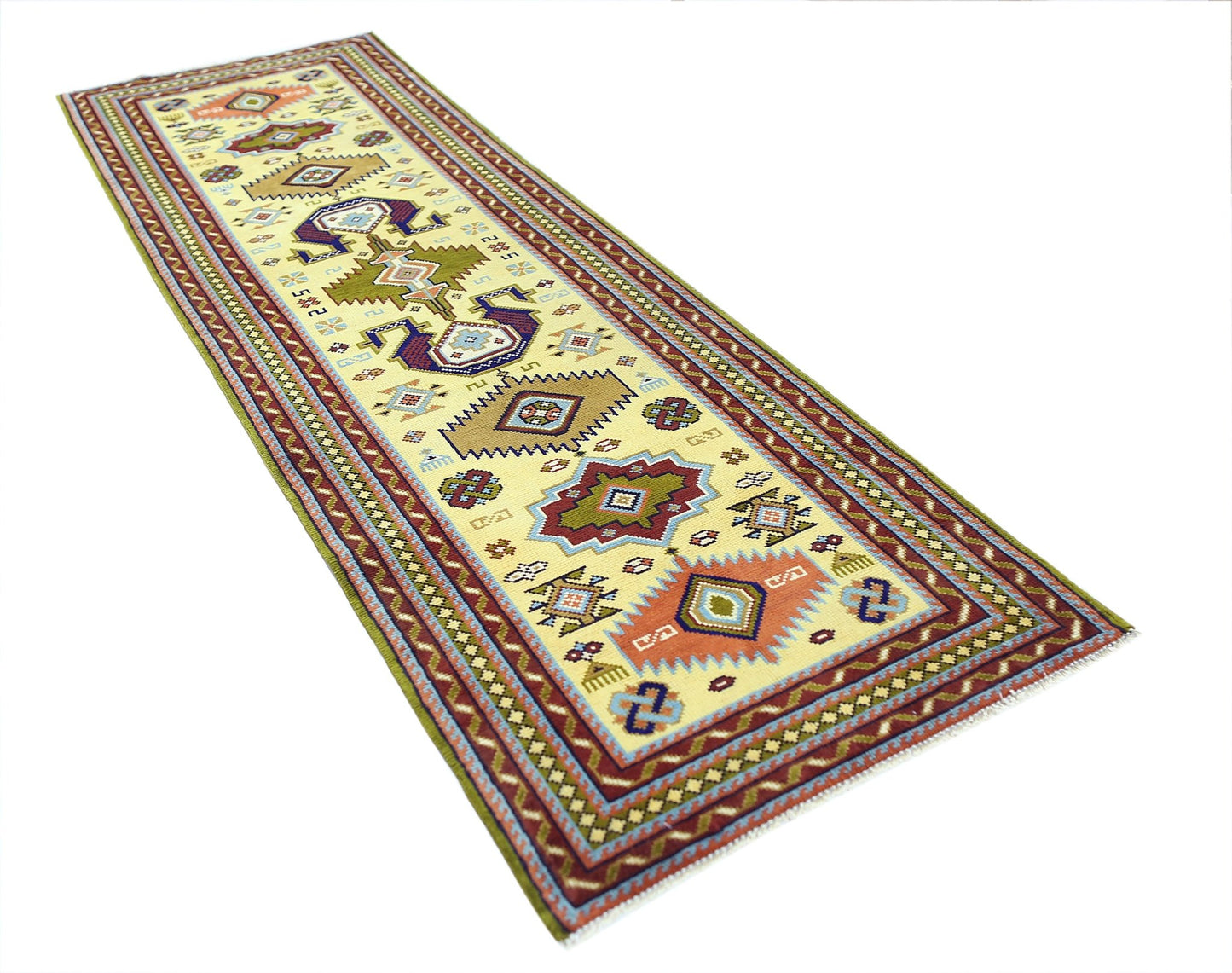 A vintage Turkish runner rug featuring geometric patterns in red, blue, and green on a cream base.