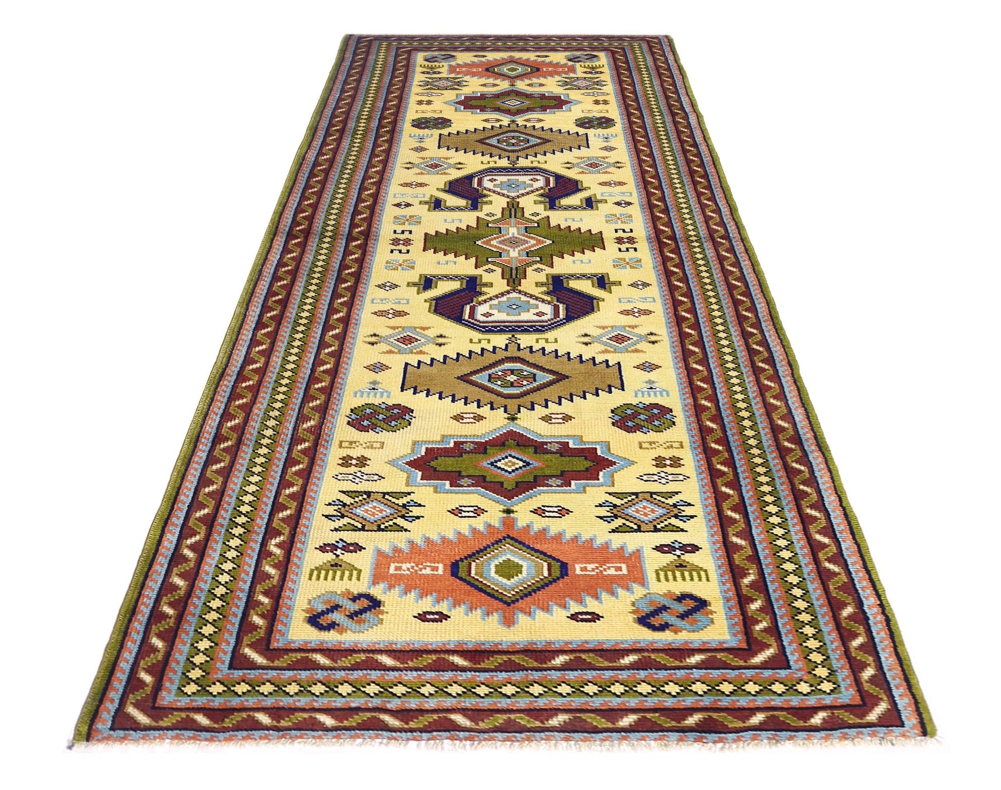 A vintage handmade Turkish runner rug featuring geometric patterns in earthy tones on a cream base.