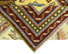 A close-up of a vintage Turkish runner featuring geometric patterns in red, blue, and yellow.