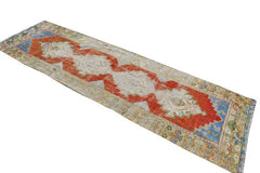 Vintage Turkish runner with red, cream, and blue tribal patterns.