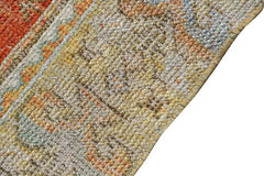 Vintage Turkish runner with tribal motifs in muted colors.