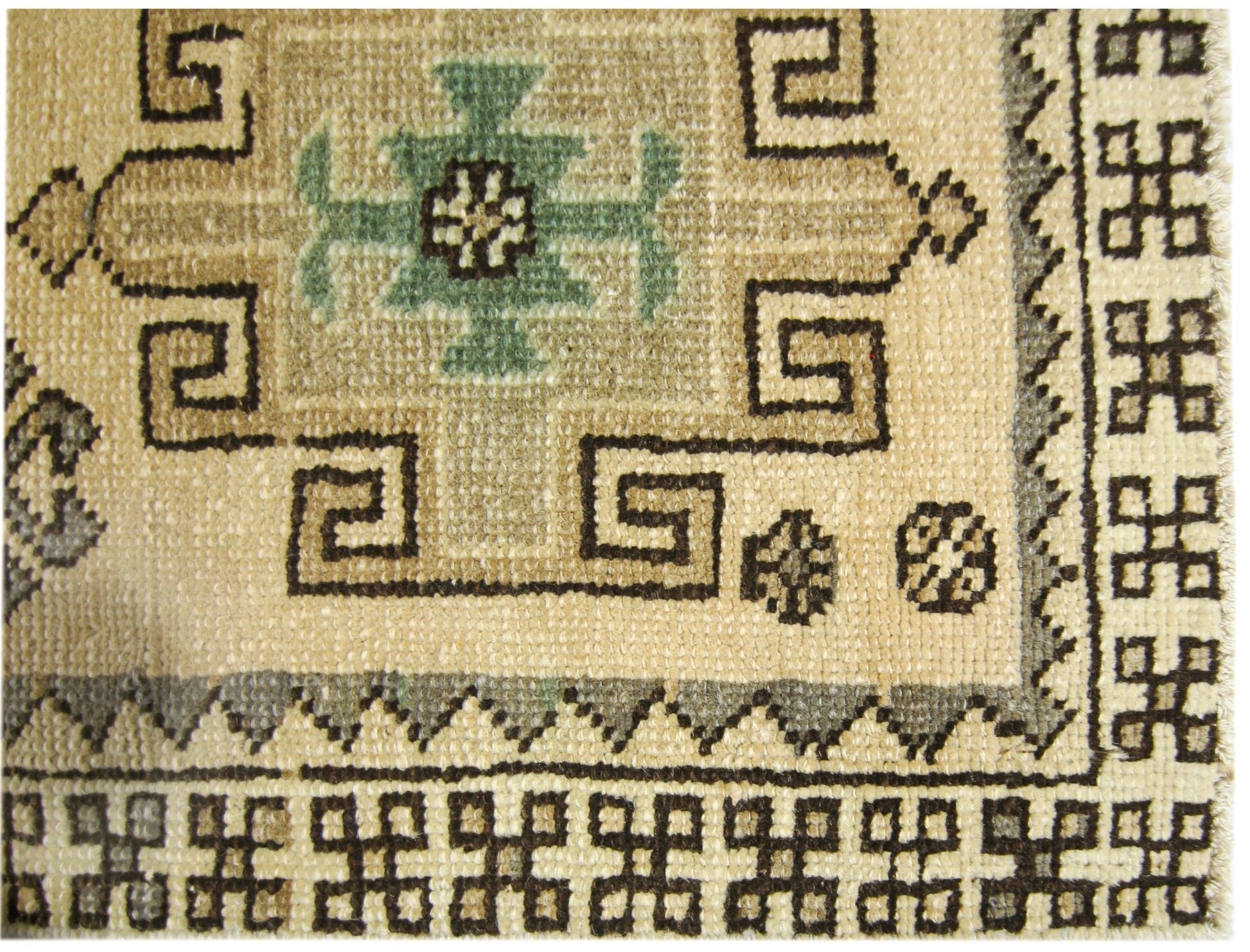 A vintage Turkish Anatolian runner featuring a geometric pattern in beige, green, and brown.