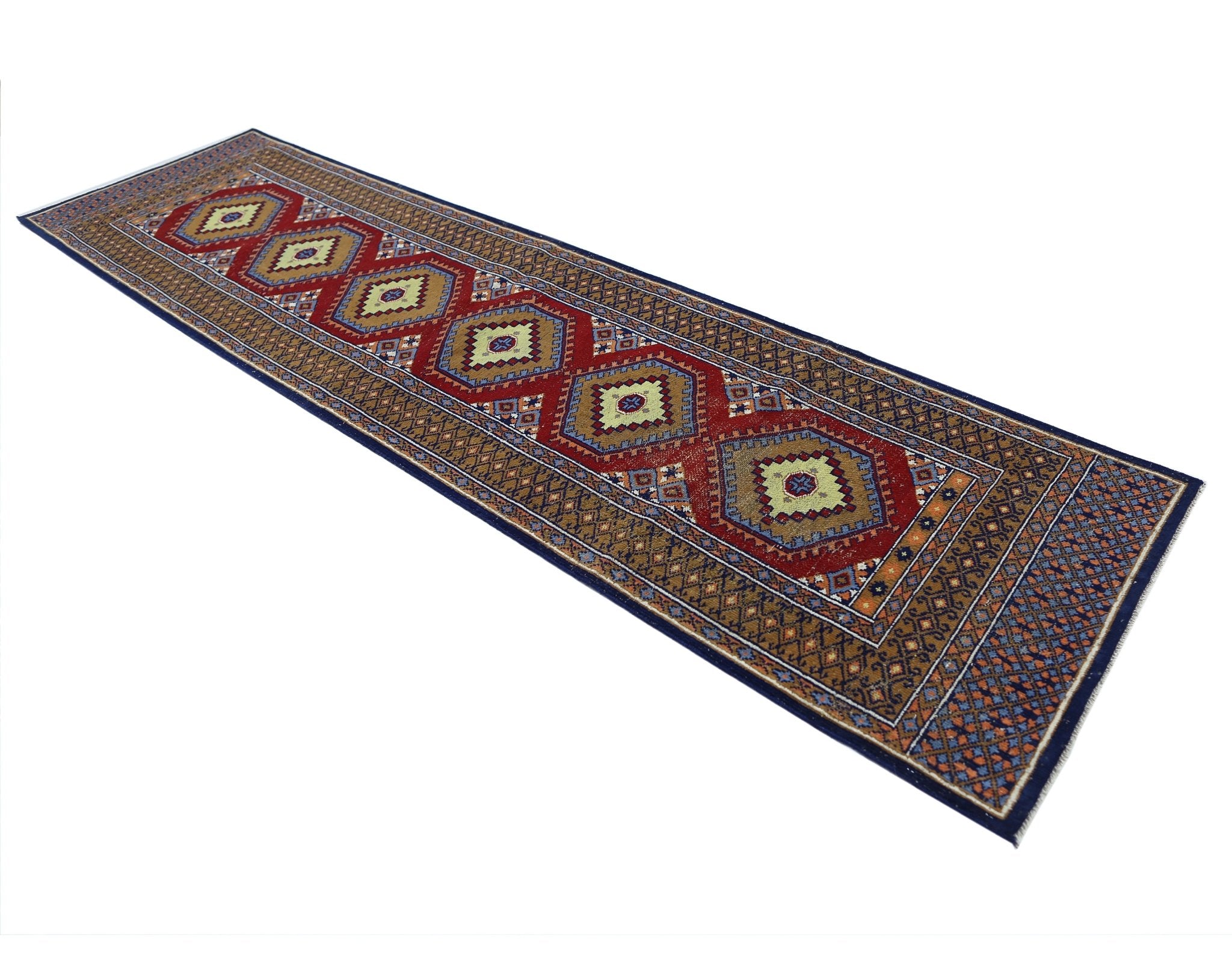 A handmade vintage Princess Bokhara runner featuring repeating geometric medallions in red and gold.