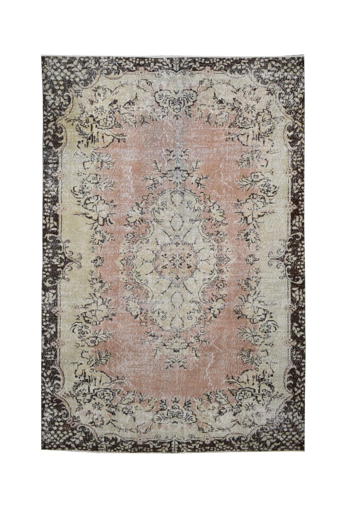 A vintage Turkish Isparta rug featuring a floral medallion on a pink field with a dark border.