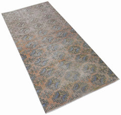 Vintage Turkish Isparta runner with a geometric pattern in muted orange and blue tones.