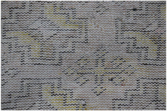 A close-up of a vintage Turkish Isparta runner featuring a faded geometric pattern in wool.