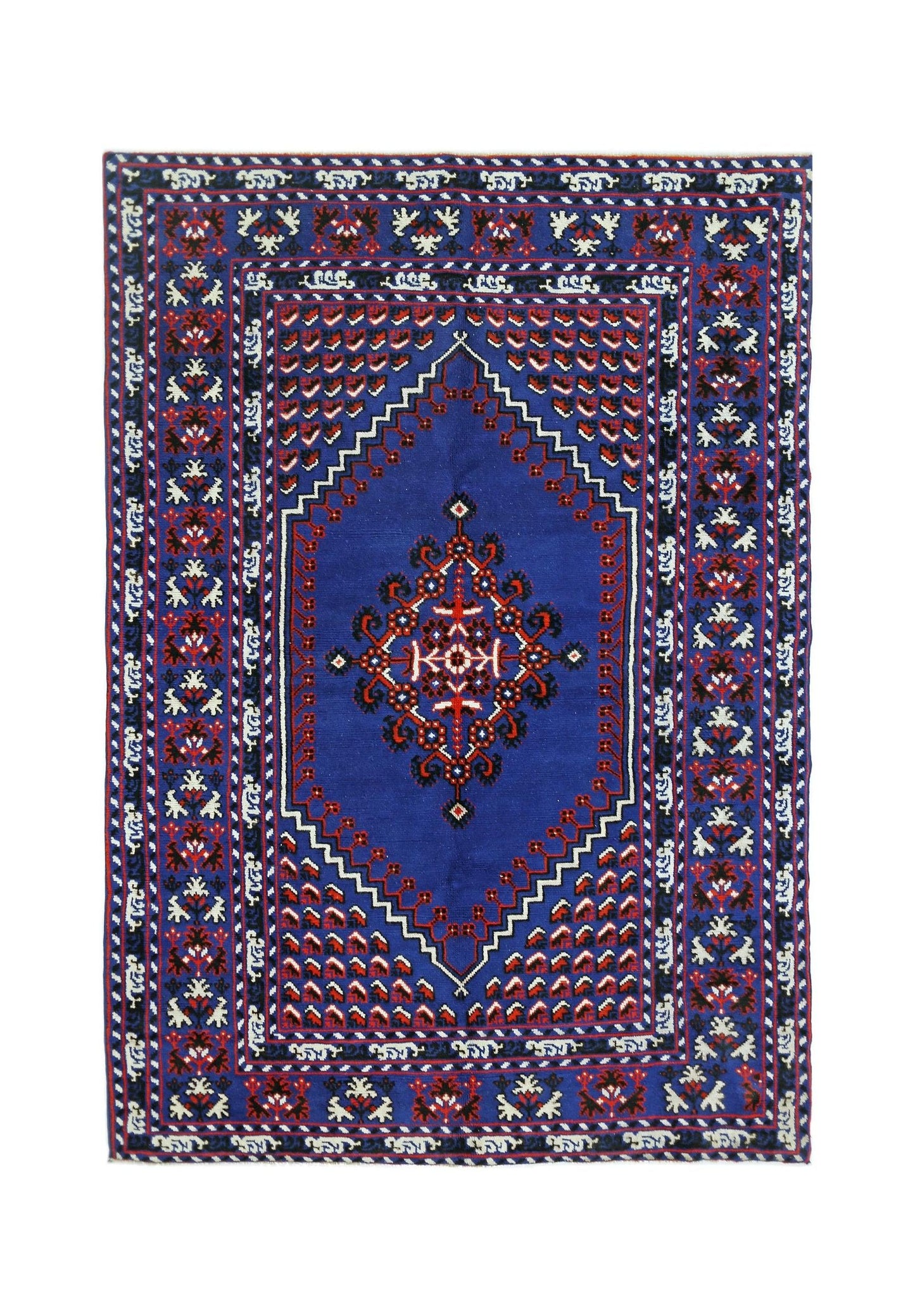 A vintage handmade Turkish rug featuring a blue field with a central medallion and geometric motifs.