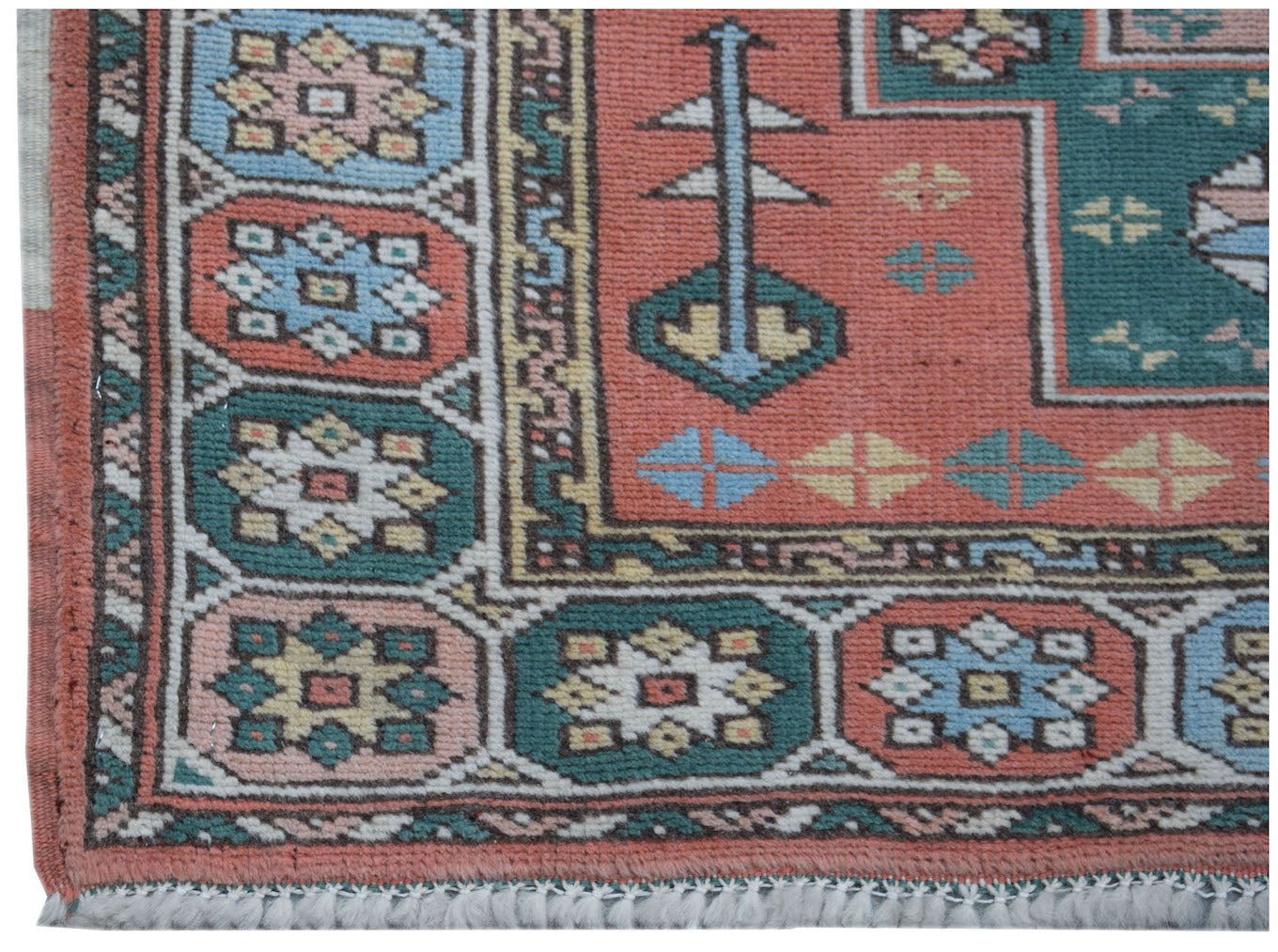 A vintage handwoven Turkish Kars runner featuring geometric patterns in muted red, blue, and green.