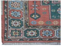 A vintage handwoven Turkish Kars runner featuring geometric patterns in muted red, blue, and green.
