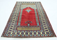A handmade vintage Turkish Kayseri prayer rug featuring a red field with floral and lamp motifs.