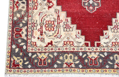 Vintage Turkish runner with red, cream, and gray geometric patterns.
