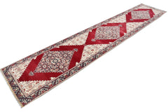 Vintage Turkish runner with red, cream, and grey geometric patterns.