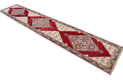 Vintage Turkish runner with red, cream, and gray geometric patterns.