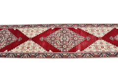 Vintage Turkish runner with red, cream, and gray geometric patterns.