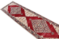 Vintage Turkish runner with red, cream, and grey geometric patterns.