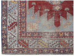 A vintage Turkish Kula rug featuring geometric patterns in red, blue, and yellow wool.