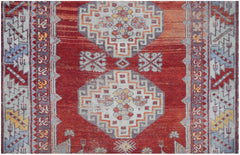 A vintage Turkish Kula rug featuring geometric patterns in red, orange, and blue tones.