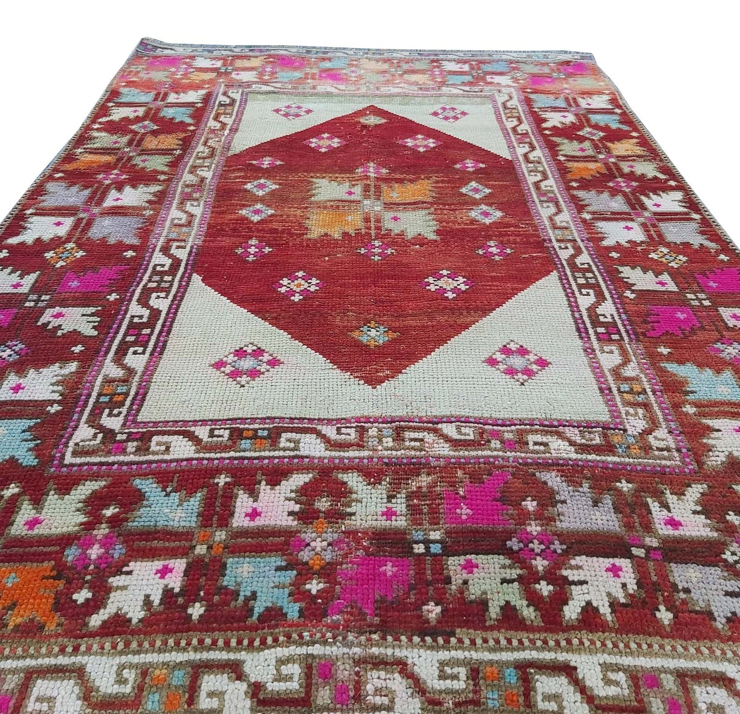 A vintage handmade Turkish Kula rug featuring a central red diamond and geometric patterns.