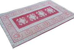 A vintage handmade Turkish Milas rug featuring geometric patterns in red, grey, and cream.