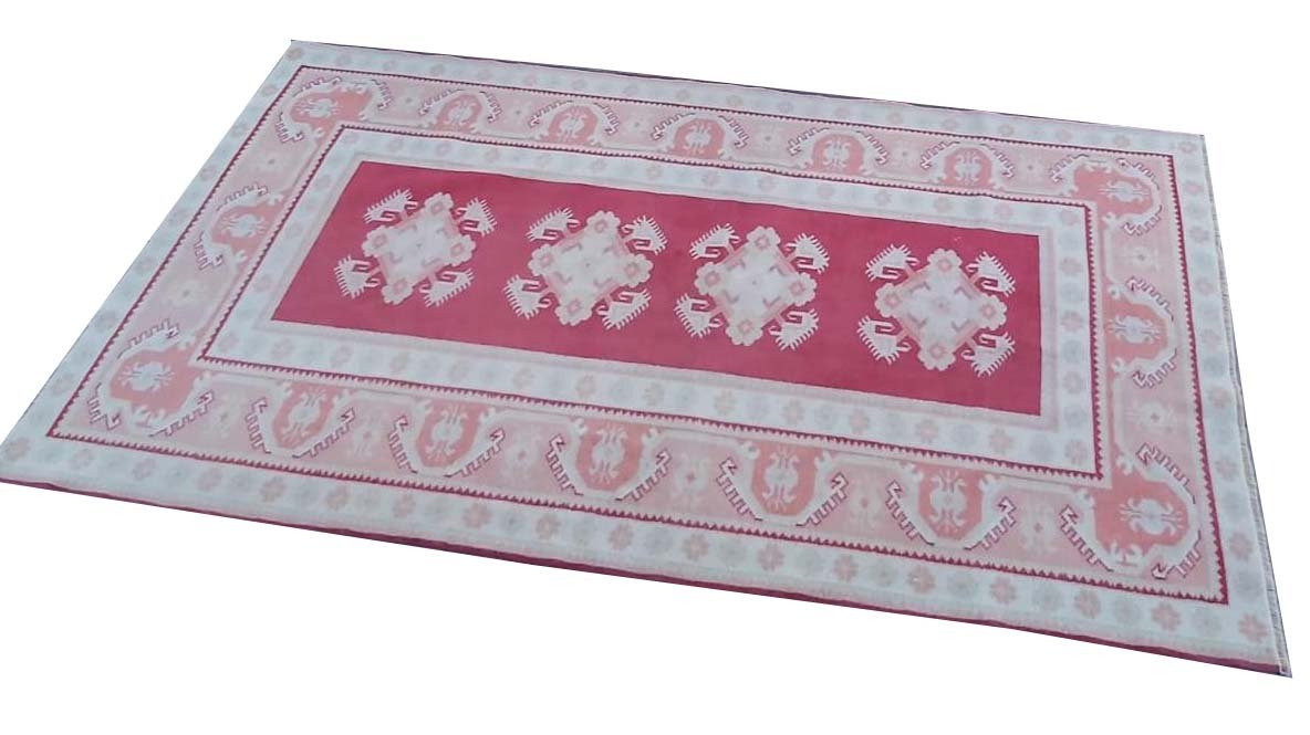 A vintage handmade Turkish Milas rug featuring geometric patterns in red, white, and grey.