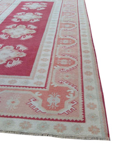 A vintage handmade Turkish Milas rug featuring geometric patterns in red, grey, and beige.