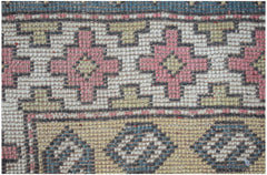 Vintage Turkish Milas rug with geometric patterns in pink, green, and blue.