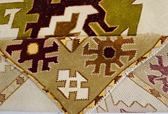 A vintage Turkish Milas rug featuring geometric patterns in olive green, brown, and cream wool.