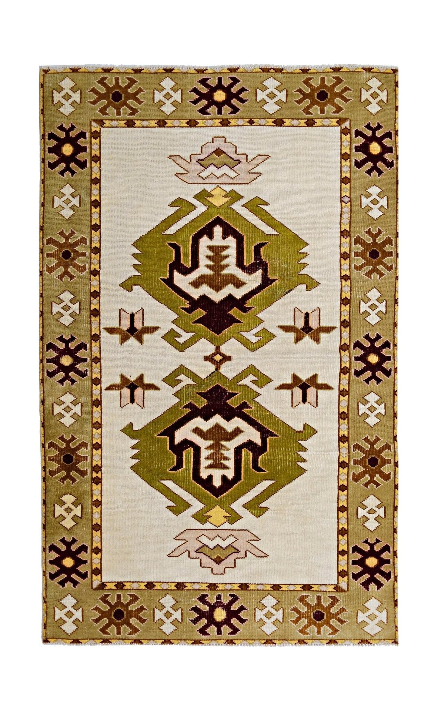 A vintage handmade Turkish Milas rug featuring geometric green and brown motifs on a cream field.