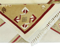 A vintage handmade Turkish Milas rug featuring geometric patterns in red, beige, and cream.