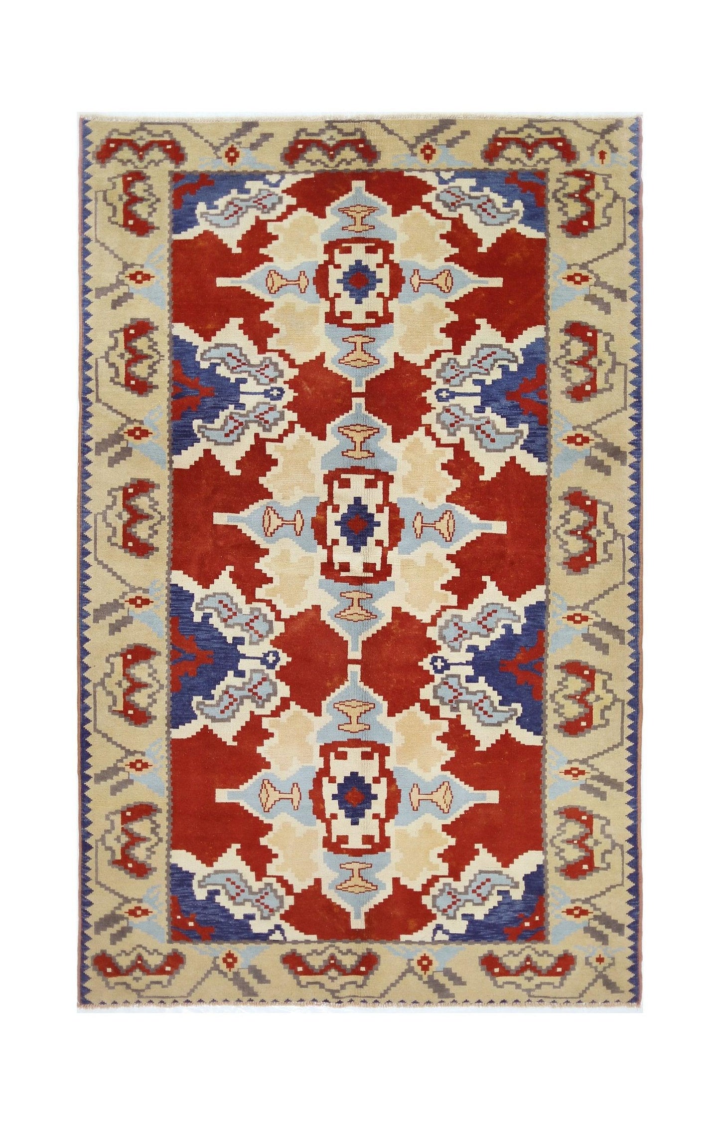 A vintage handmade Turkish rug featuring a geometric pattern in red, blue, and cream tones.