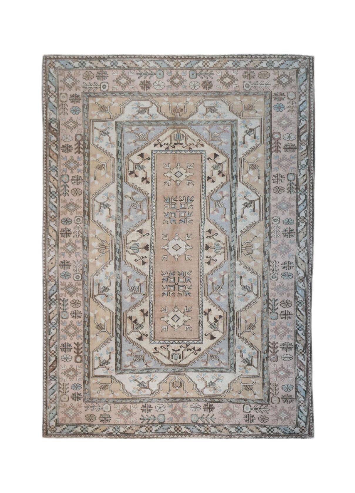 A vintage handmade Turkish Milas rug featuring a traditional geometric pattern in soft earth tones.