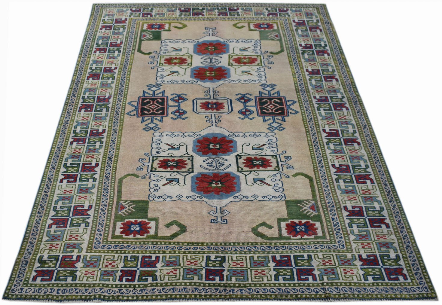 A vintage Turkish Oushak rug featuring a traditional floral pattern in red, blue, and green.