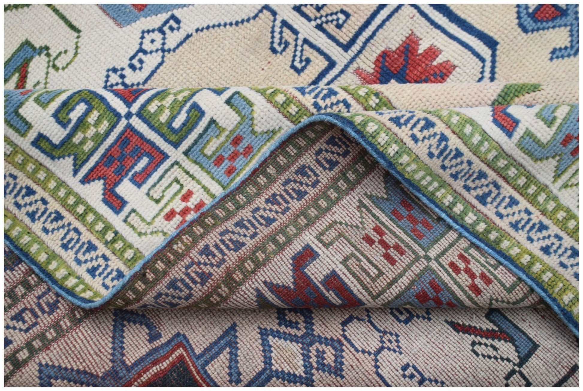 A vintage Turkish Oushak rug featuring a traditional geometric pattern in blue, red, and green.
