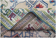 A vintage Turkish Oushak rug featuring a traditional geometric pattern in blue, red, and green.