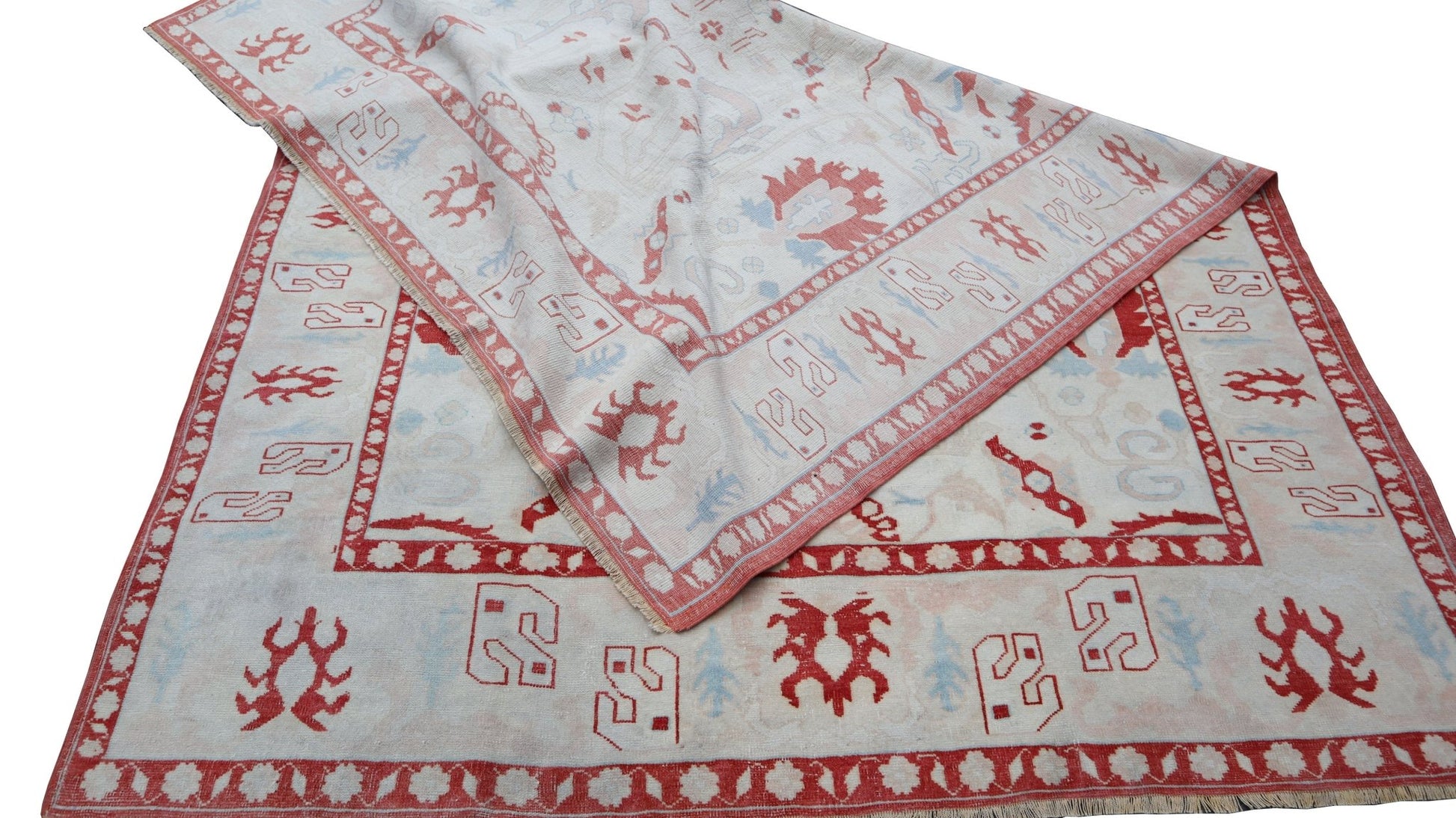 A vintage handmade Turkish Oushak rug featuring a traditional red and white geometric pattern.