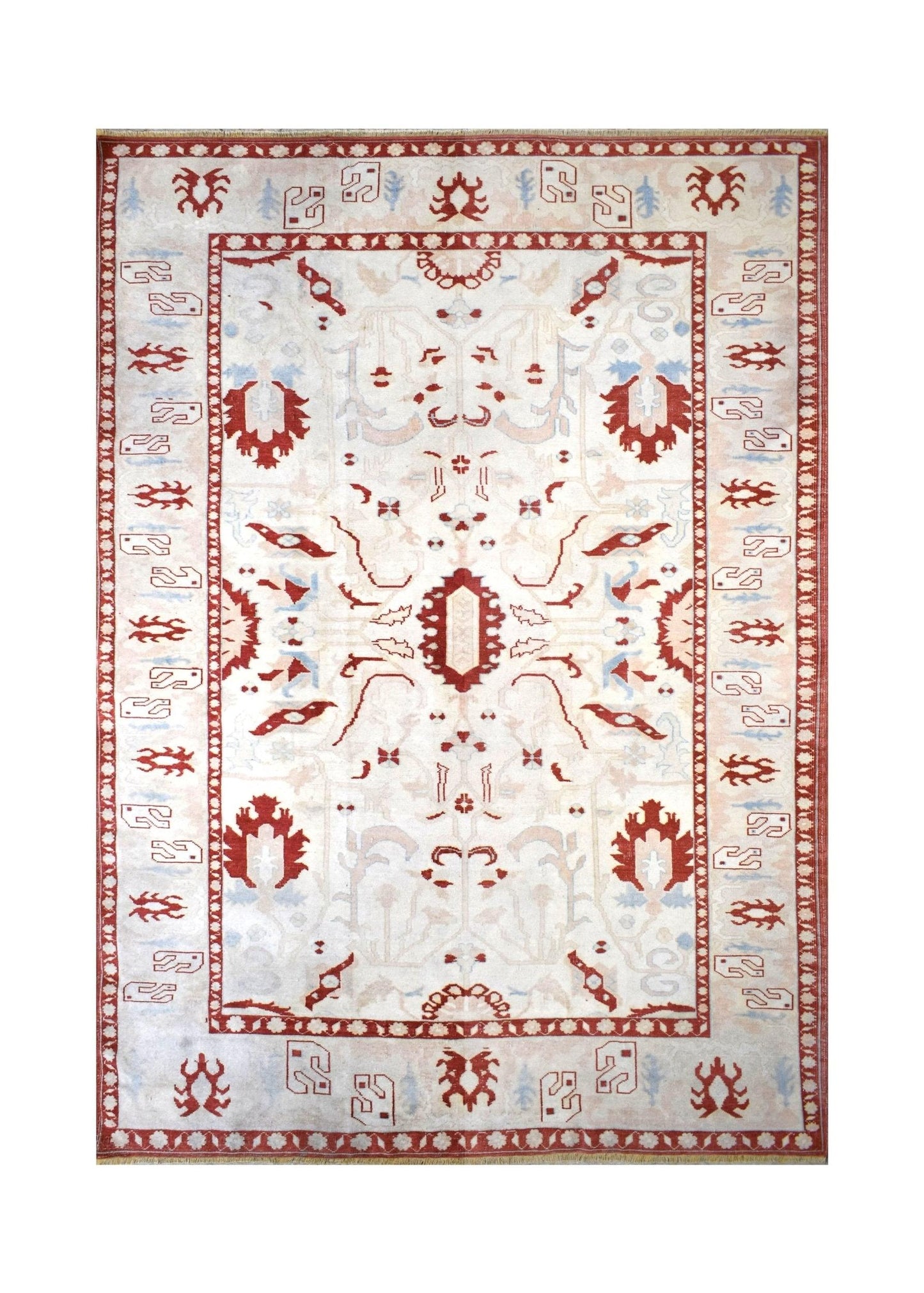 A vintage Turkish Oushak rug featuring a traditional red and cream geometric pattern.