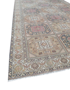 A vintage handmade Turkish Oushak rug featuring a geometric pattern of octagonal medallions.