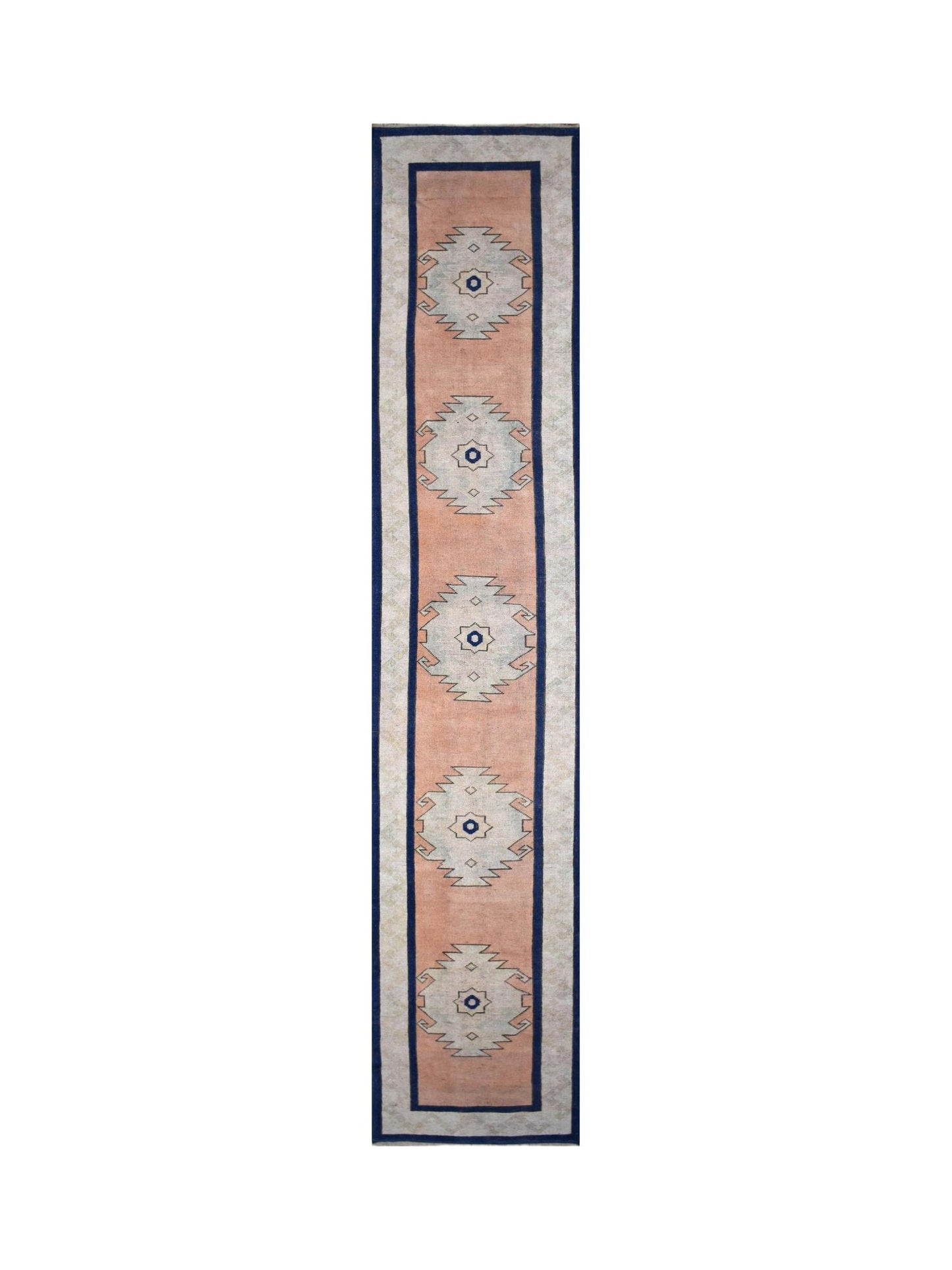 A vintage Turkish Oushak runner featuring five geometric medallions on a peach field.