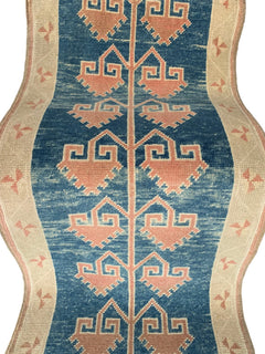 A vintage Turkish Oushak runner featuring pink geometric tribal motifs on a blue field.