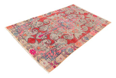 A vintage handmade Turkish wool rug featuring a distressed geometric pattern in red and grey.