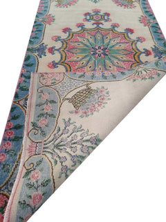 A vintage handmade Turkish wool runner featuring a floral medallion pattern in blue and pink.