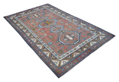 A vintage handwoven Turkish rug featuring geometric patterns in shades of red, blue, and cream.
