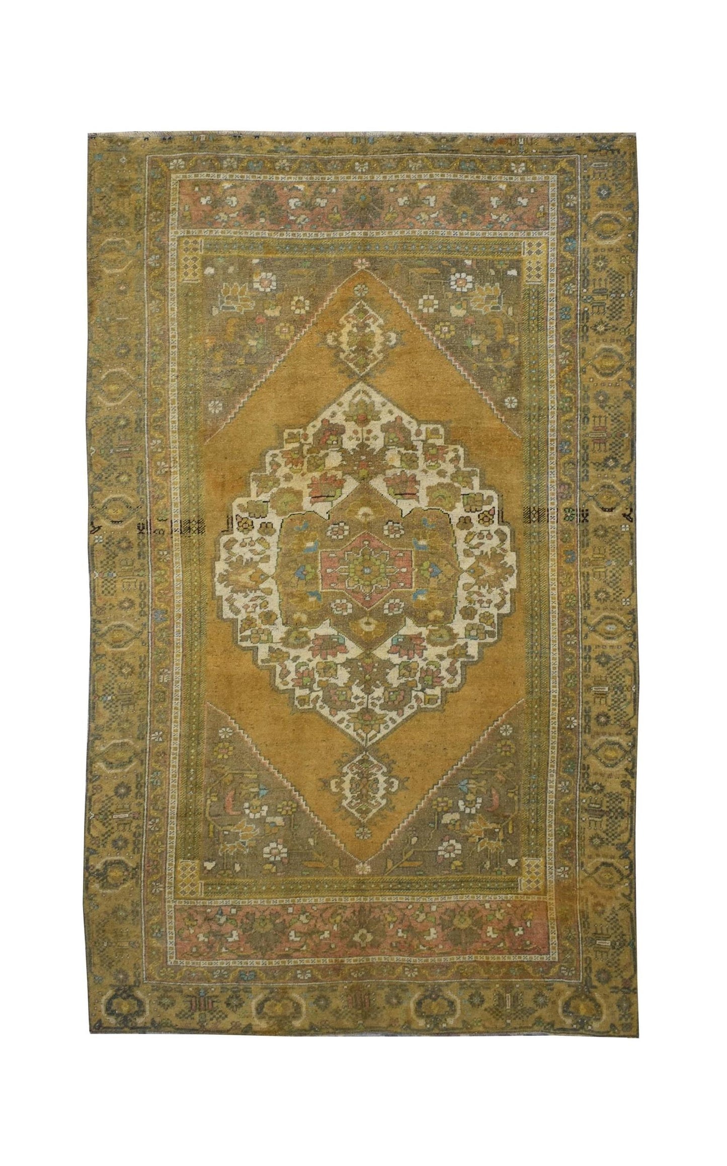 A vintage handmade Turkish wool rug featuring a central diamond medallion on a mustard field.