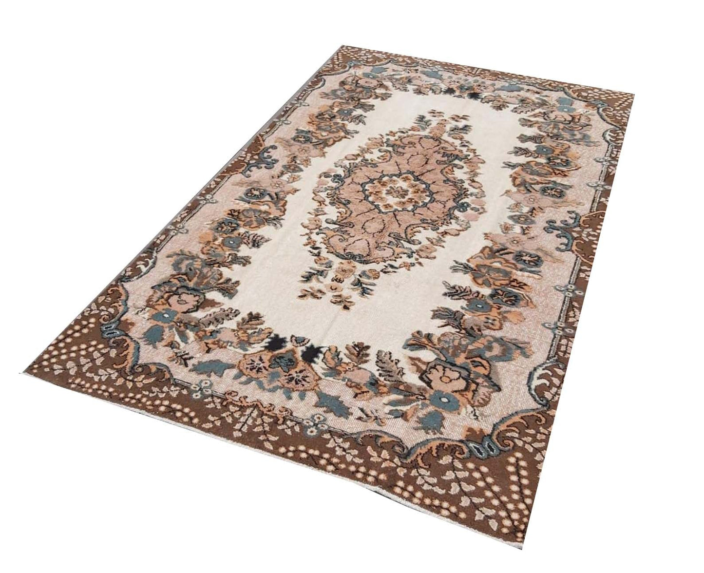 A vintage handmade Turkish Isparta rug featuring a floral central medallion and a dark brown border.