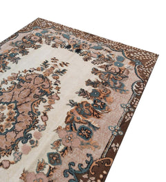 A vintage handmade Turkish Isparta rug featuring a floral pattern with a cream center and brown border.